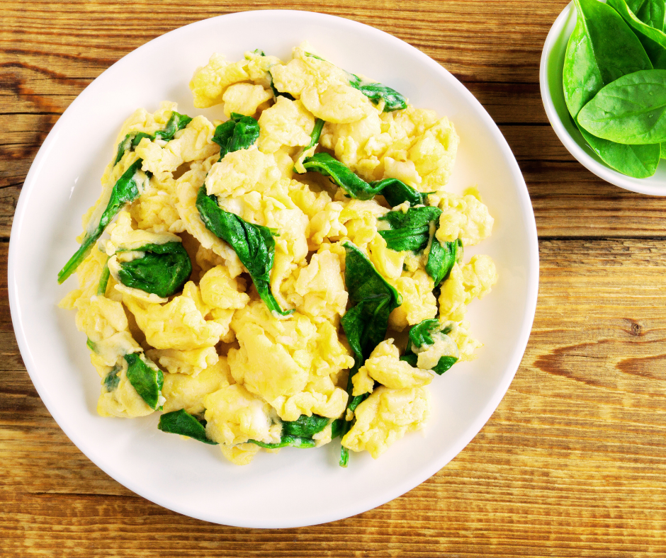 Basil scrambled eggs with wilted spinach and seared baby tomatoes